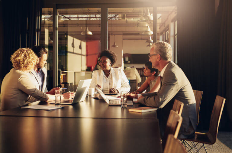 Group of diverse businesspeople meeting around a boardroom table