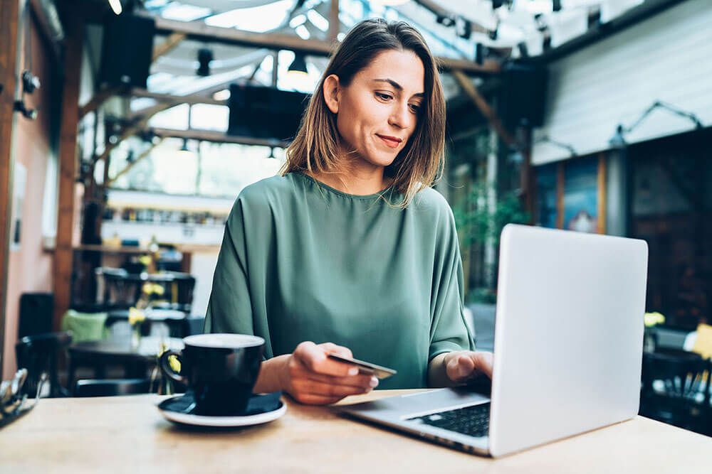 Woman studying laptop looking at tax notices